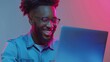 © Studio Nova - Man Smiling at Colorful Laptop Screen