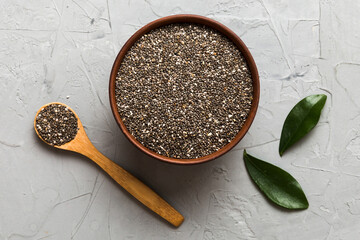 Wall Mural - Chia seeds in bowl and spoon on colored background. Healthy Salvia hispanica in small bowl. Healthy superfood
