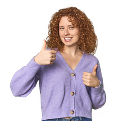 Wall Mural - Young Caucasian redhead woman raising both thumbs up, smiling and confident.