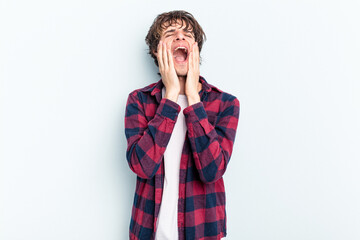 Wall Mural - Young caucasian man isolated on blue background whining and crying disconsolately.