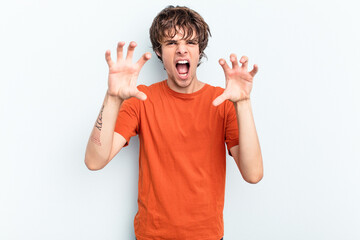 Poster - Young caucasian man isolated on blue background upset screaming with tense hands.