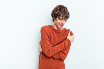 Wall Mural - Young caucasian man isolated on blue background laughing and having fun.