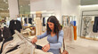© FotoAndalucia - A Spanish woman in a shopping mall buys clothes and fashion of different kinds