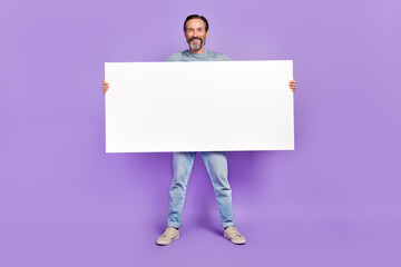 full body photo of aged man hold big paper white banner promotion isolated over violet color backgro