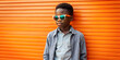 Boy with sunglasses, casual in front of colorful wall with space for text
