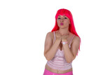 Fototapeta  - Woman dressed like a doll. Young beautiful sexy woman in camisole and pink skirt on white background. Red hair girl wears pink wig with fringe. Showing emotions. Sending air kisses