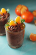 Chocolate mousse dessert with tangerines in glasses
