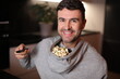 © ajr_images - Hilarious man using the hood of the hoodie to store his popcorn while watching tv