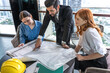 © Jack Tamrong - Business develop man discuss and brainstorming with young architect women about big construction project
