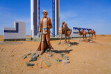 Fototapeta Krajobraz - Sculpture of a camel train caravan along the ancient silk road at the gateway to the Khorezm Region of Uzbekistan, located along the A380 highway in the Kyzylkum Desert in Central Asia