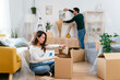 © Connect Images - Couple organizing home during moving day.