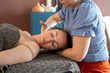 © Connect Images - Massage therapist working on a relaxed client