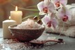 A bowl of sea salt next to a candle. Perfect for spa or relaxation concepts