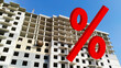 Large red 3d Percentage sign on Residential building background. Rising prices for sale and rental of Flat. Interest Rate. Apartment. House under construction. Mortgage concept. Unfinished real estate