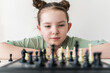 Little girl playing chess. Selected Focus
