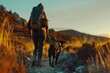 a hiker with a backpack and a dog walking along a mountain trail during golden hour, with the warm light of sunset