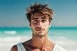 Handsome young man in casual white top against bright beach background