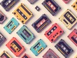 Seamless pattern of cassette tapes on a black background
