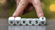 Hand turns dice and changes the word stress to rest.