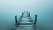 Old wooden pier extending into a misty lake
