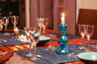 Dining table setting with glasses, decorations and candles