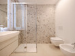 Inside a modern bathroom with marble tiles.