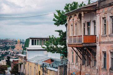 Wall Mural - View of the Sameba Cathedral and a traditional Georgian wooden balcony from Mtatsminda neighborhood in Tbilisi, Georgia