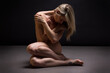 Artistic sports conceptual photo of a naked beautiful woman. Beauty nude yoga girl posing on black background. 
