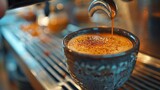 Barista pouring a perfect espresso shot into a ceramic cup