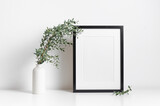 Fototapeta Lawenda - Frame mockup in white minimalistic interior with botanical decor, blank mockup for artwork