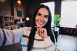 © deagreez - Photo of lovely young woman take selfie photo thoughtful wear striped outfit interior home living room in brown warm color
