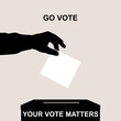 Go vote.Silhouette of voter hand putting ballot into voting box