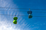 Fototapeta Las - Colorful, old-fashioned cable car or chairlift in an amusement park. Green and blue empty vintage gondola against a blue sky on a sunny day in the famous boardwalk of Santa Cruz, California (USA).