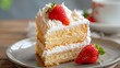 a slice of tres leche cake topped with white cream and decorated wit a ripe red strawberry