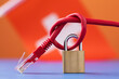 A closed lock on a tied network wire into a knot against the background of the Swiss flag, the concept of security of Internet technologies in the country