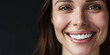 Craft an impactful banner featuring a close-up of a stunning woman's beautiful smile with perfect white teeth against a dark black backdrop. Ideal for dental health and beauty-related concepts.