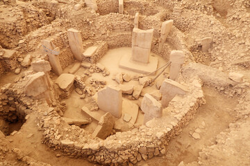 Enclosure C at the neolithic archaeological site of Göbekli Tepe, Potbelly Hill, central pillar 37 with a fox on it and pillar 27 with a cat chasing a boar clearly visible, close to Sanliurfa, Turkey