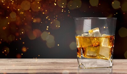 Wall Mural - Glass of cold alcohol drink on wooden desk