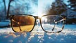 a sunny winter image divided in half showing the difference between a glasses lens with vs without anti-glare coating