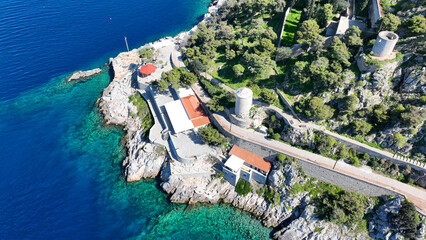 Wall Mural - Aerial drone photo of famous small seaside swimming area of Hydroneta next to main village of Hydra island, Saronic gulf, Greece