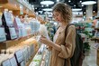 © Pinklife - Female shopper reading label on organic bath product in a health and beauty aisle