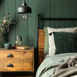 Close-up of a headboard with black metal and wooden elements, colorful pillows, a black metal sconce on green wall panels, flowers in a vase, and decor on a wooden nightstand.