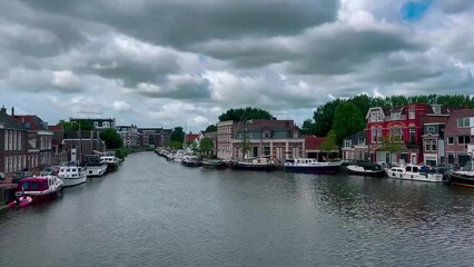 Wall Mural - Traditional Dutch architecture of old houses and pier in historical center of Sneek, the Netherlands August 20, 2023. High quality 4k footage