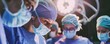 A highly skilled surgical team performs a complex operation in a blue-lit operating room, showcasing focus and precision