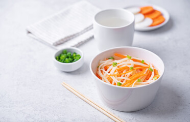 Wall Mural - Daikon radish carrot noodles salad in a bowl