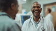 © Maksym - Against the backdrop of hospital activity, a male doctor's face lights up with joy as he shares optimistic updates with a patient, his demeanor reflecting genuine care and dedicati