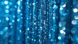 Blue curtains embellished with sequins create a sparkling, glittery background, perfect for holiday decorations or photo booth drapes