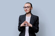 Portrait of thinking serious confident business woman , on grey studio background