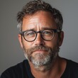 © AIDigitalart - Professional headshot of a creative director, modern glasses, neutraltoned background, engaging and confident