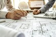 A close up photo shows two people working on blueprints and drawings in an architectural design office Generative AI